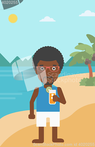 Image of Man with cocktail on the beach.