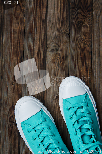 Image of sneakers on empty wooden surface