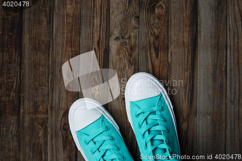 Image of shoes on empty wooden floor