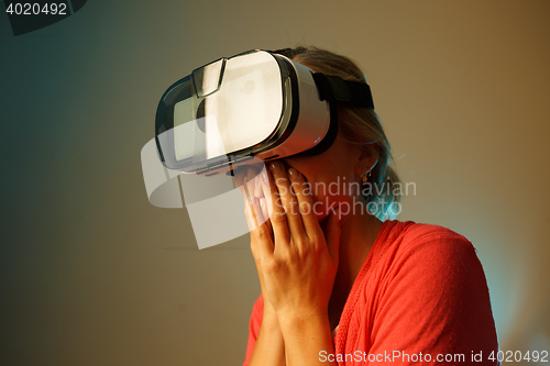 Image of happy young woman with virtual reality headset or 3d glasses