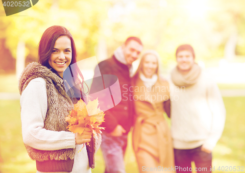 Image of group of friends having fun in autumn park