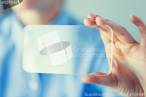 Image of close up of woman with transparent smartphone