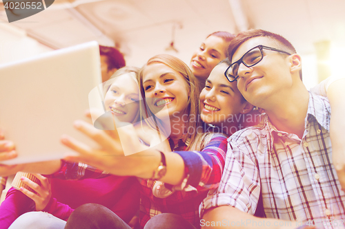 Image of group of smiling students with tablet pc