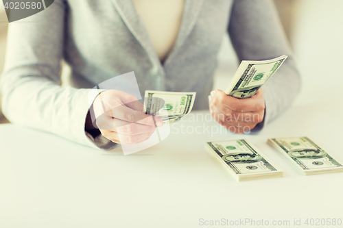 Image of close up of woman hands counting us dollar money