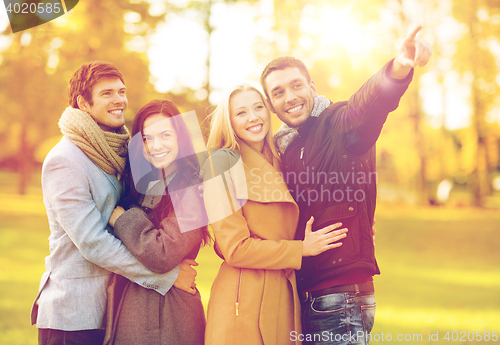 Image of group of friends having fun in autumn park