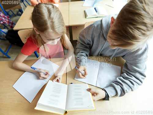 Image of high school students reading book and learning