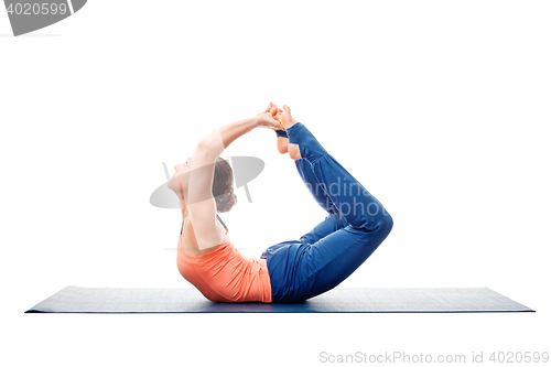 Image of Sporty fit woman practices yoga asana Dhanurasana