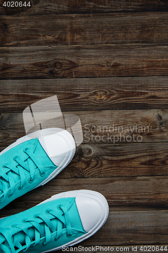 Image of sneakers on empty wooden floor