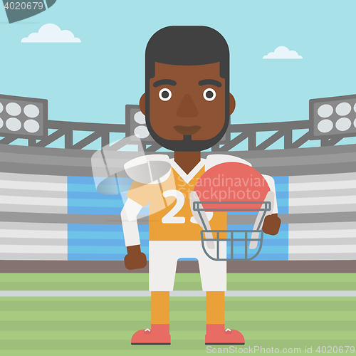 Image of Rugby player with ball and helmet in hands.