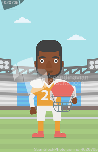 Image of Rugby player with ball and helmet in hands.