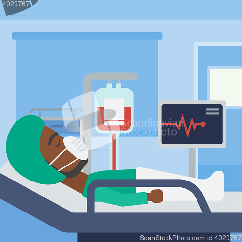 Image of Patient lying in hospital bed with heart monitor.