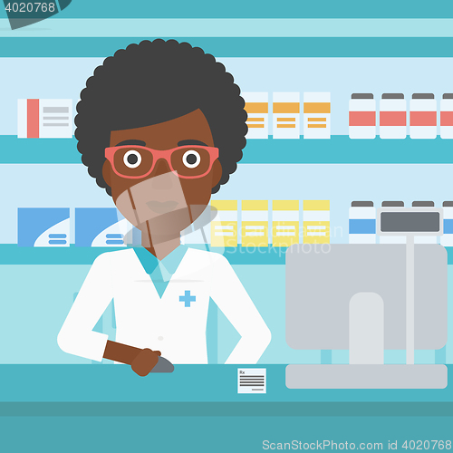 Image of Pharmacist at counter with computer monitor.