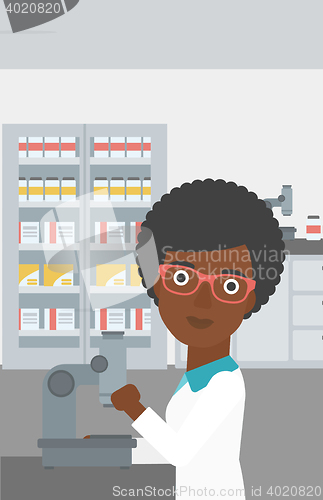 Image of Laboratory assistant with microscope.