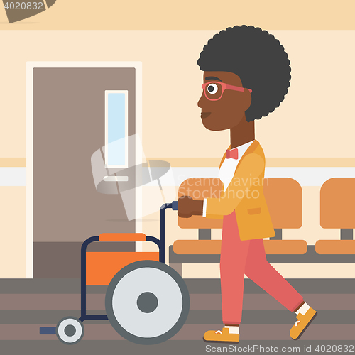 Image of Woman pushing wheelchair.