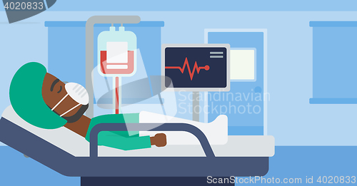 Image of Patient lying in hospital bed with heart monitor.