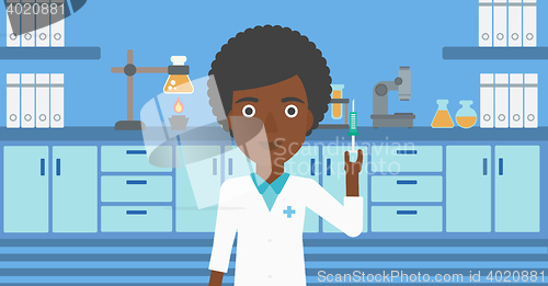 Image of Laboratory assistant with syringe in lab.