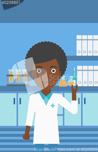 Image of Laboratory assistant with syringe in lab.