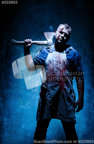 Image of Bloody Halloween theme: crazy killer as butcher with an ax