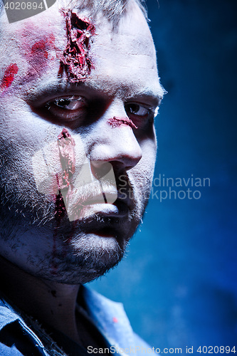 Image of Bloody Halloween theme: crazy killer as young man with blood