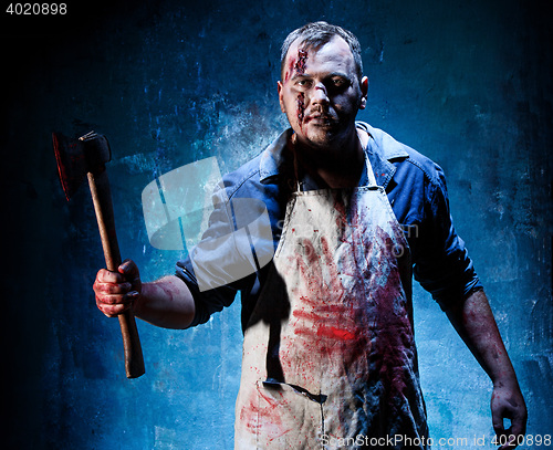 Image of Bloody Halloween theme: crazy killer as butcher with an ax