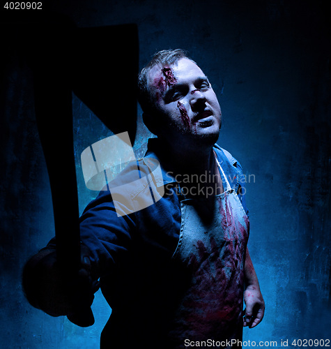 Image of Bloody Halloween theme: crazy killer as butcher with an ax