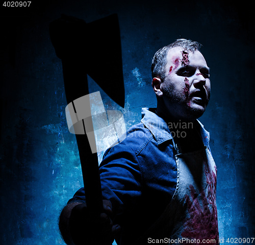 Image of Bloody Halloween theme: crazy killer as butcher with an ax