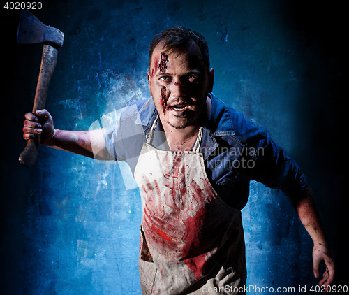 Image of Bloody Halloween theme: crazy killer as butcher with an ax