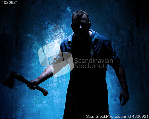 Image of Bloody Halloween theme: crazy killer as butcher with an ax