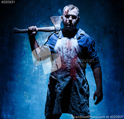 Image of Bloody Halloween theme: crazy killer as butcher with an ax