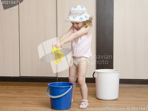 Image of Little girl wash rag in the bucket