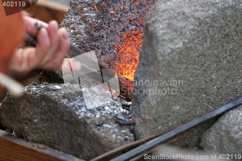 Image of stoking the fire