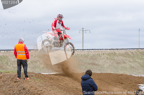 Image of Volgograd, Russia - April 19, 2015: Spectators watch as the racers bouncing on the trampoline on stage the Open Championship motorcycling Cup cross-country Volgograd Region Governor