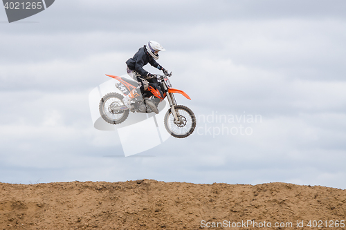 Image of Volgograd, Russia - April 19, 2015: Motorcycle racer jumped above the ground on the springboard, at a stage of the open championship motorcycling Cup cross-country Volgograd Region Governor