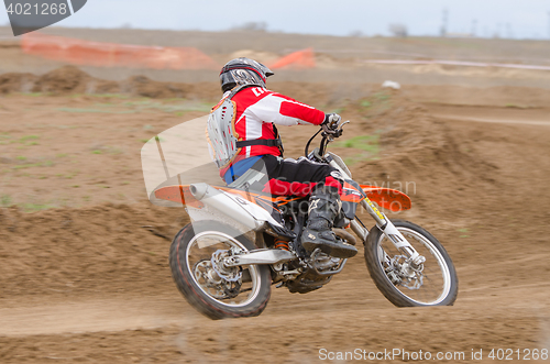 Image of Volgograd, Russia - April 19, 2015: Motorcycle racer enters a turn into a protracted, step Open Championship Motorcycle Cross Country Cup Volgograd Region Governor