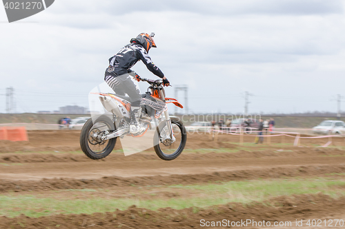 Image of Volgograd, Russia - April 19, 2015: Motorcycle racer in flight after the jump through the trampoline at the stage of the open championship motorcycling Cup cross-country Volgograd Region Governor