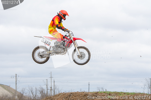 Image of Volgograd, Russia - April 19, 2015: Motorcycle racer jumping on the trampoline in flight, at the stage of the Open Championship Motorcycle Cross Country Cup Volgograd Region Governor