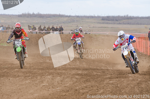 Image of Volgograd, Russia - April 19, 2015: Three riders on the track, at the stage of the Open Championship Motorcycle Cross Country Cup Volgograd Region Governor