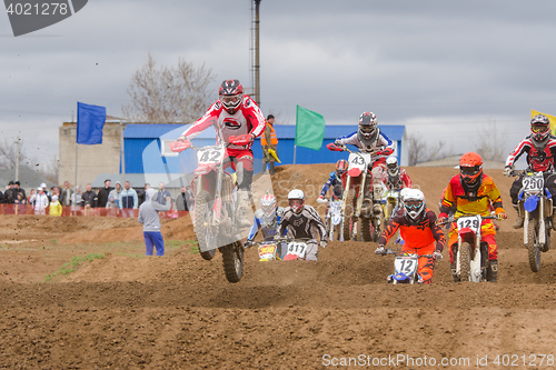 Image of Volgograd, Russia - April 19, 2015: Motorcycle racer after the start of driving on the road by a large group, at the stage of the Open Championship Motorcycle Cross Country Cup Volgograd Region Govern