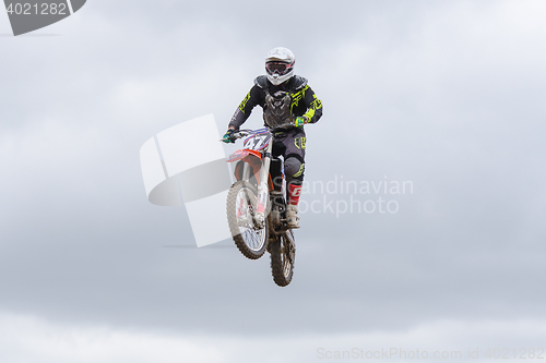 Image of Volgograd, Russia - April 19, 2015: Motorcycle racer in flight, at the stage of the Open Championship Motorcycle Cross Country Cup Volgograd Region Governor