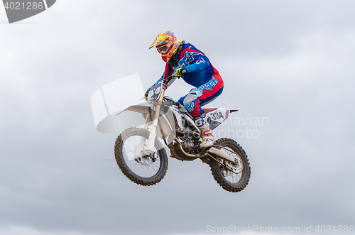 Image of Volgograd, Russia - April 19, 2015: Motorcycle racer flying jumping on the trampoline, on the stage of the open championship motorcycling Cup cross-country Volgograd Region Governor