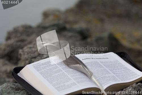 Image of Bible with quill