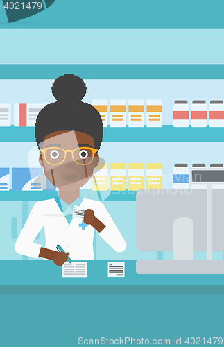 Image of Pharmacist writing prescription.