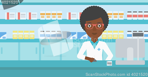 Image of Pharmacist at counter with computer monitor.