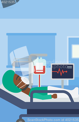 Image of Patient lying in hospital bed with heart monitor.