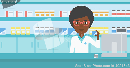 Image of Pharmacist showing some medicine.