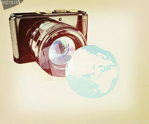 Image of 3d illustration of photographic camera and Earth. 3D illustratio