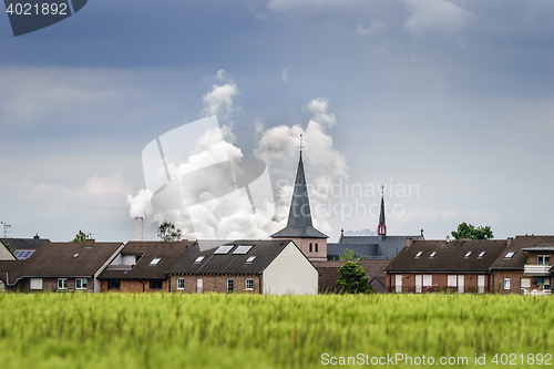 Image of Village with ugly coulds in background