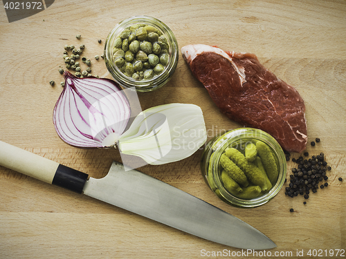 Image of mixing steak tartare ingredients in a bowl