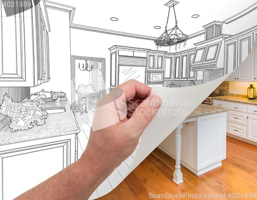 Image of Hand Turning Page of Custom Kitchen Drawing to Photograph.
