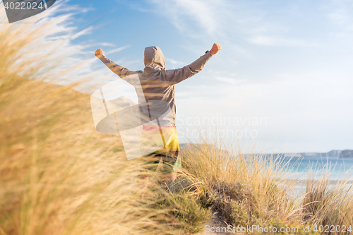 Image of Sporty active man enjoying beauty of nature.